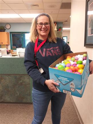Woman holding box of colorful easter eggs