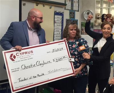 Dave Sant from Cyprus Credit Union presenting teacher of the month check