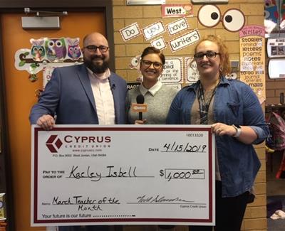 Representative from Cyprus Credit Union present Teacher of the Month Check.